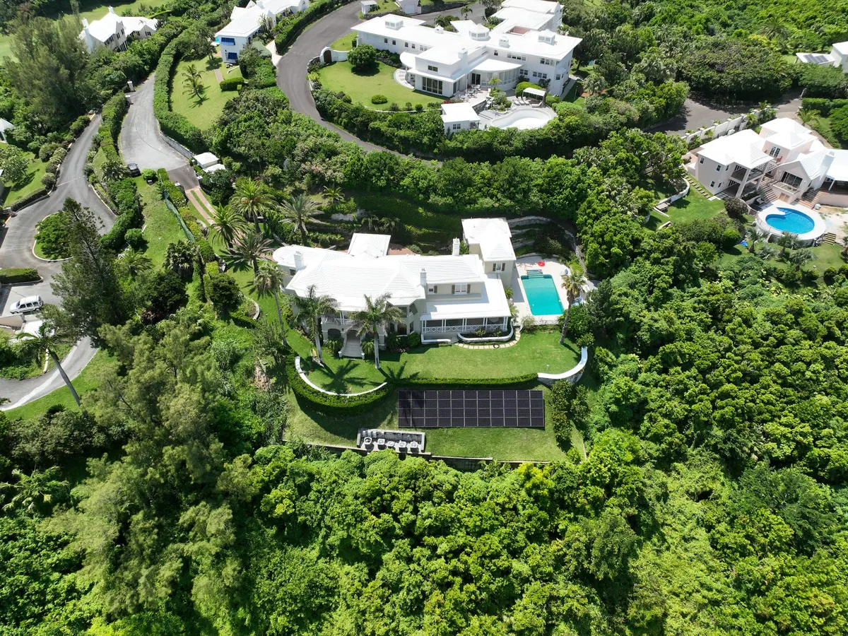 A private residence in Bermuda with Maxeon solar panels on a white roof, seen from the air