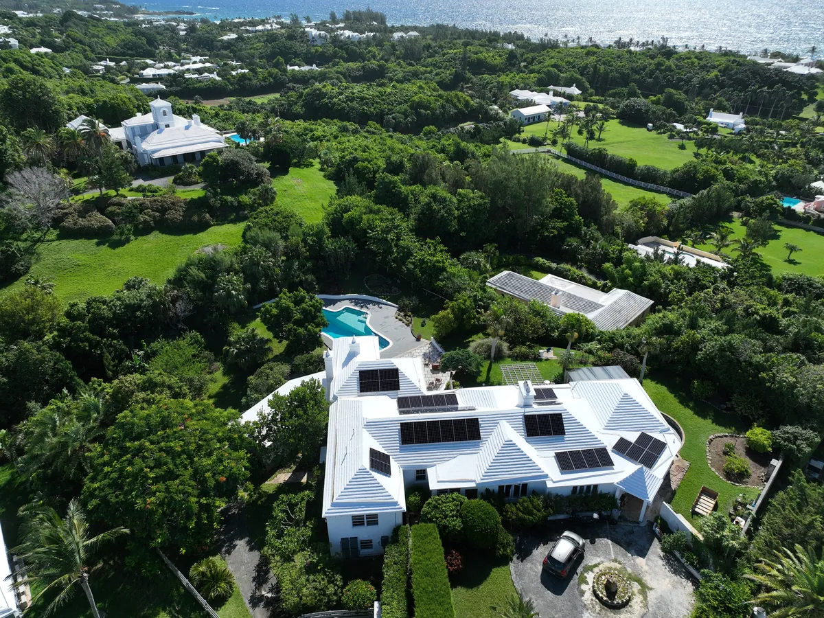A private residence in Bermuda with Maxeon solar panels on a white roof, seen from the air