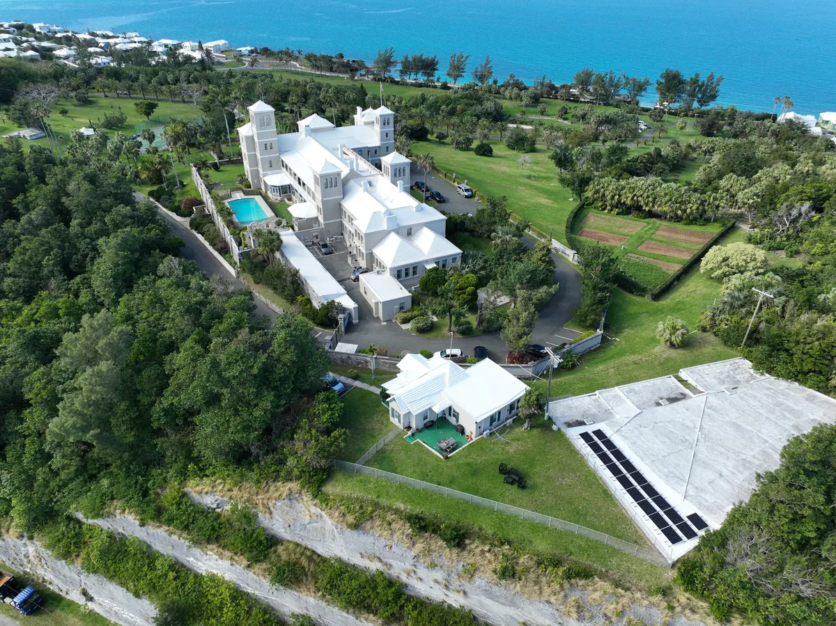 Government House, Bermuda, from the air, with a row of solar panels on the estate's outbuilding roof